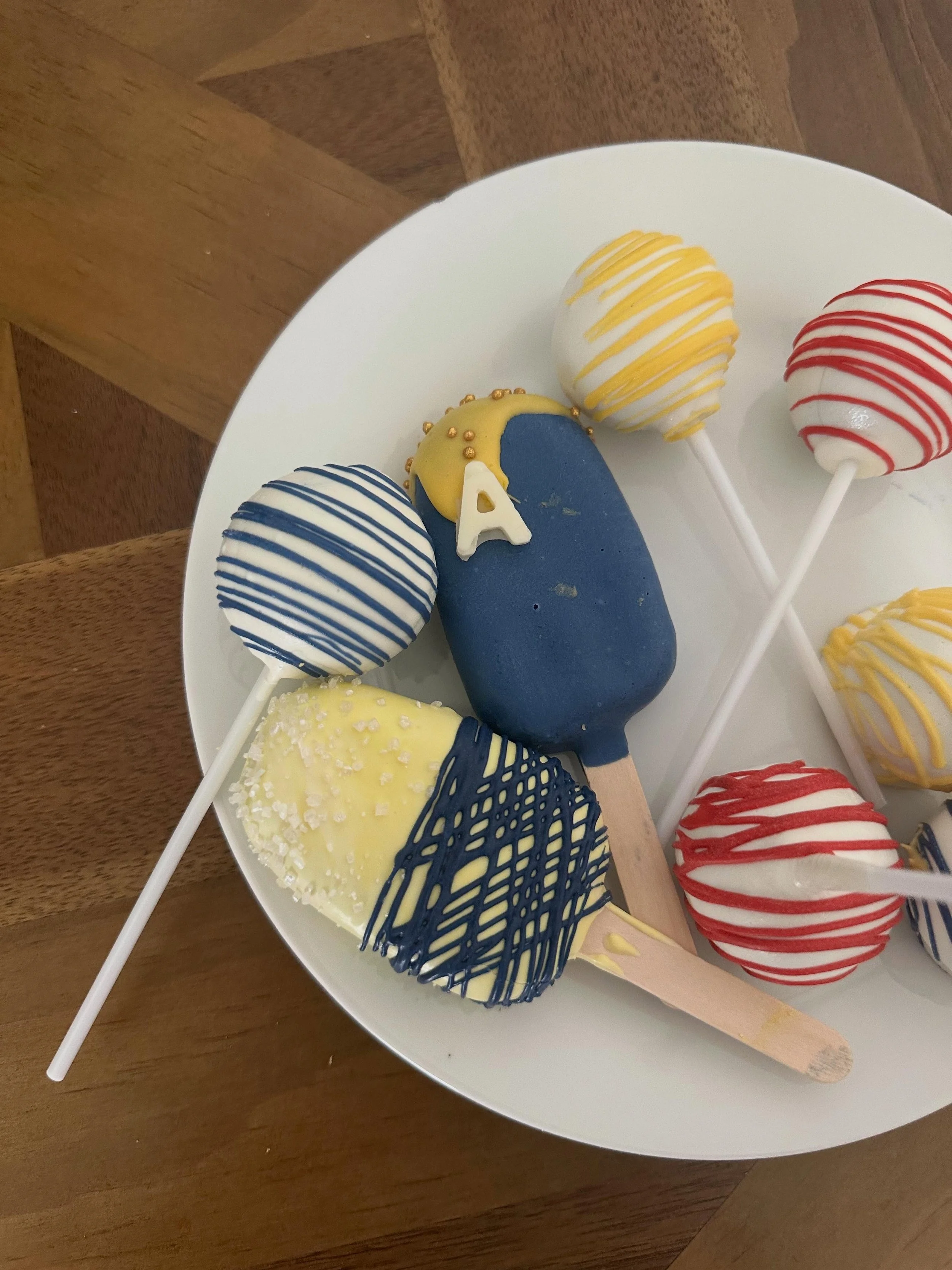 Our biggest order! Thank you so much for all your support.

24 funfetti cake pops
24 chocolate cake pops
6 cakesicles 
Theme: Aldi 💙❤️💛🤍