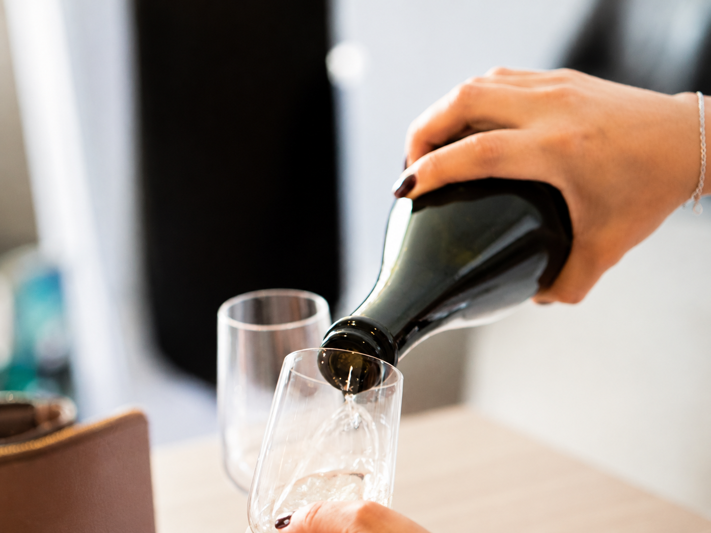 Champagne being poured into a glass, part of Front Porch Social's Mobile Bar Service in Northern Colorado