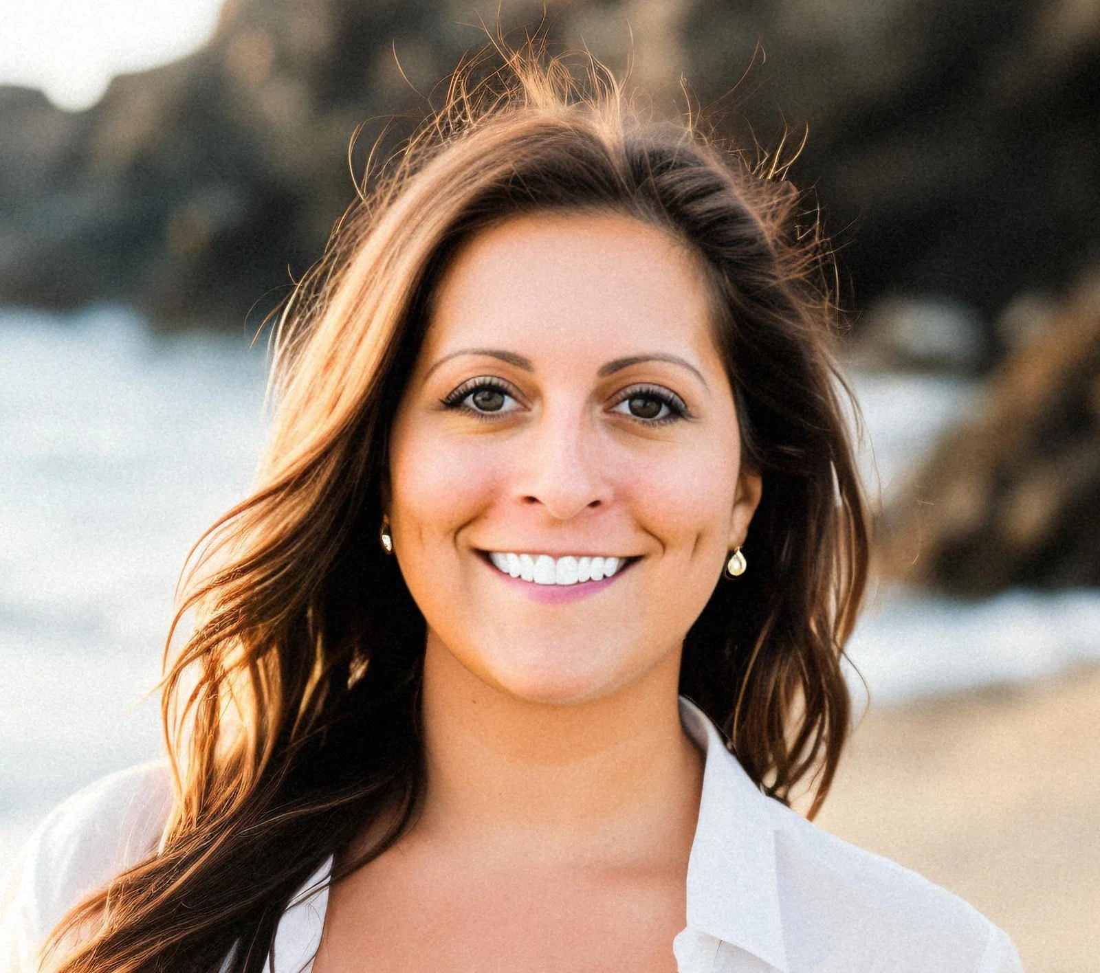 Portrait of a smiling woman with wavy brown hair, founder of Front Porch Social