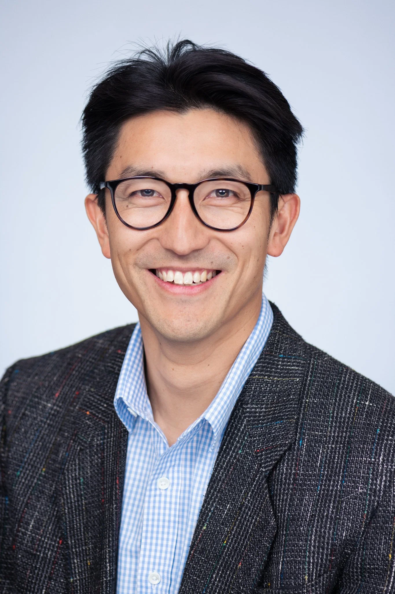 Headshot of William Taing, man with glasses smiling