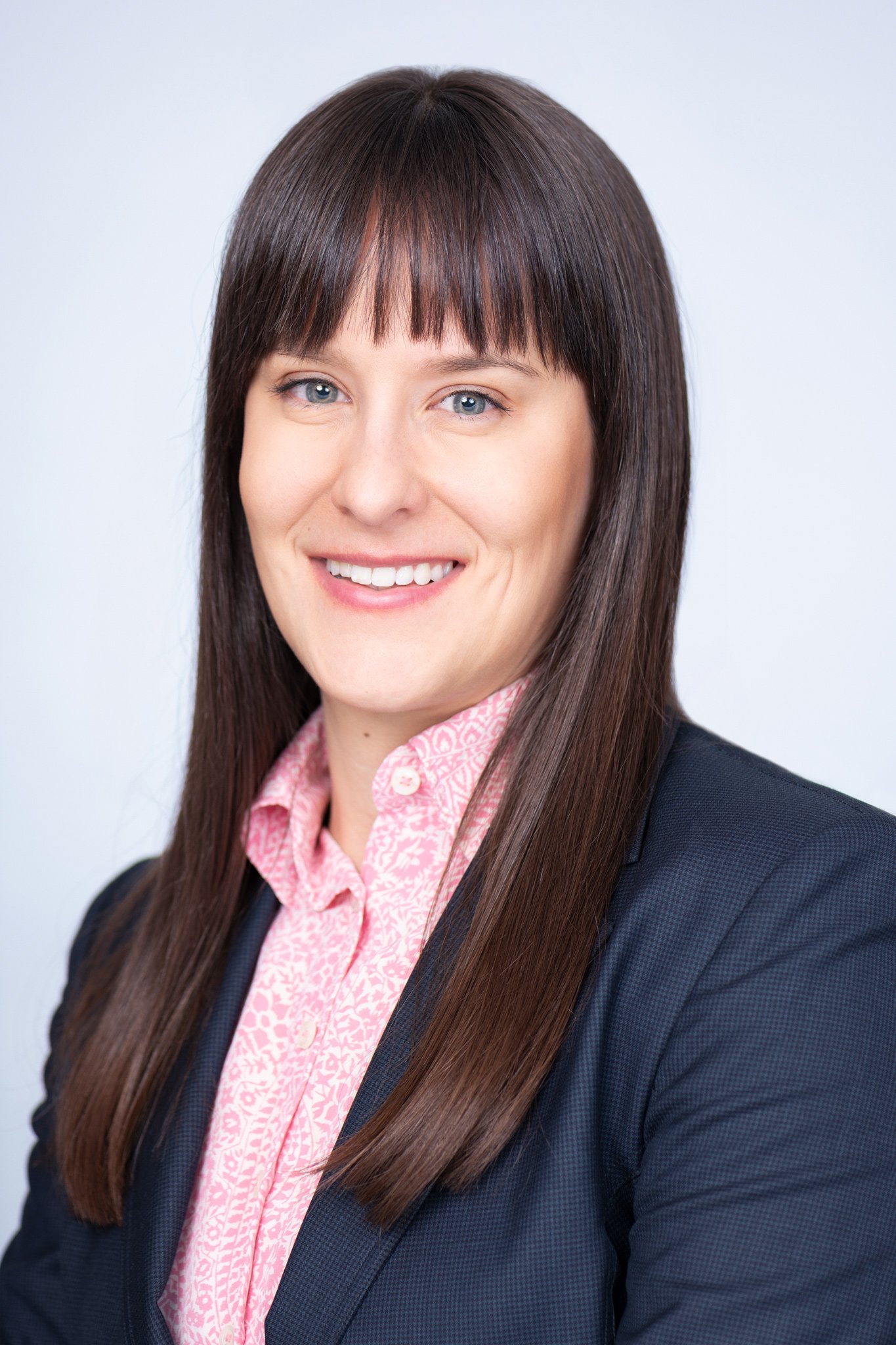 Headshot of Klara Kalocsay, A woman with long brown hair and bangs smiling