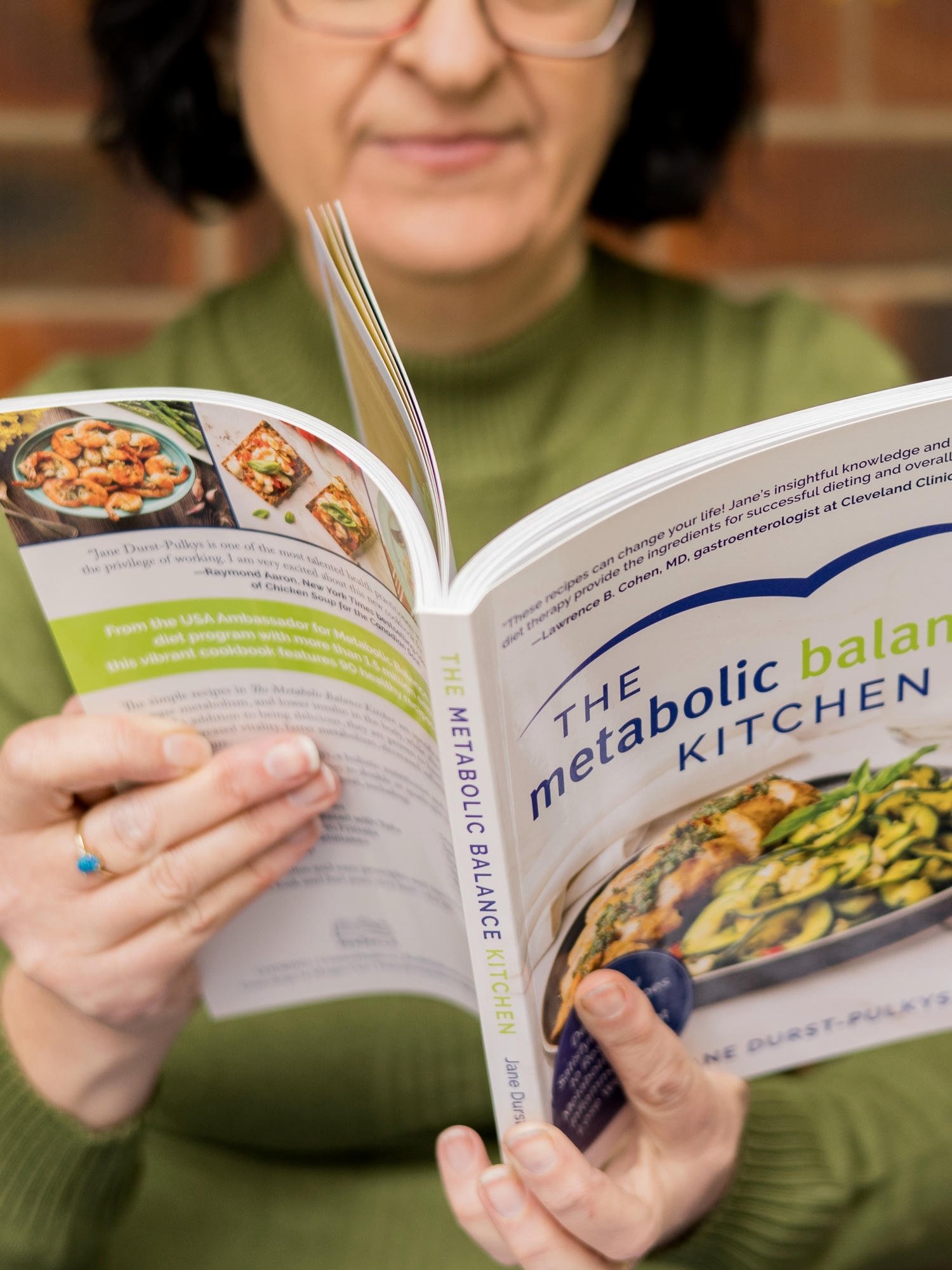 Clinical nutritionist reading The Metabolic Balance Kitchen book