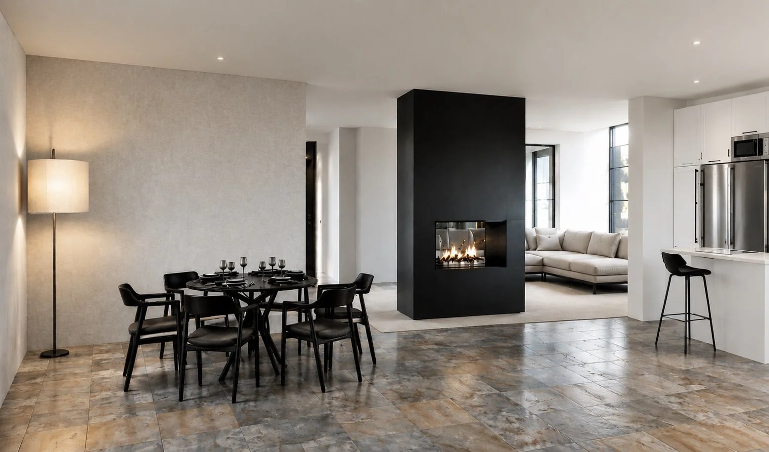 Modern open-concept living and dining area with a black dining table set, a white sectional sofa, a black fireplace, and white kitchen cabinets with stainless steel appliances.