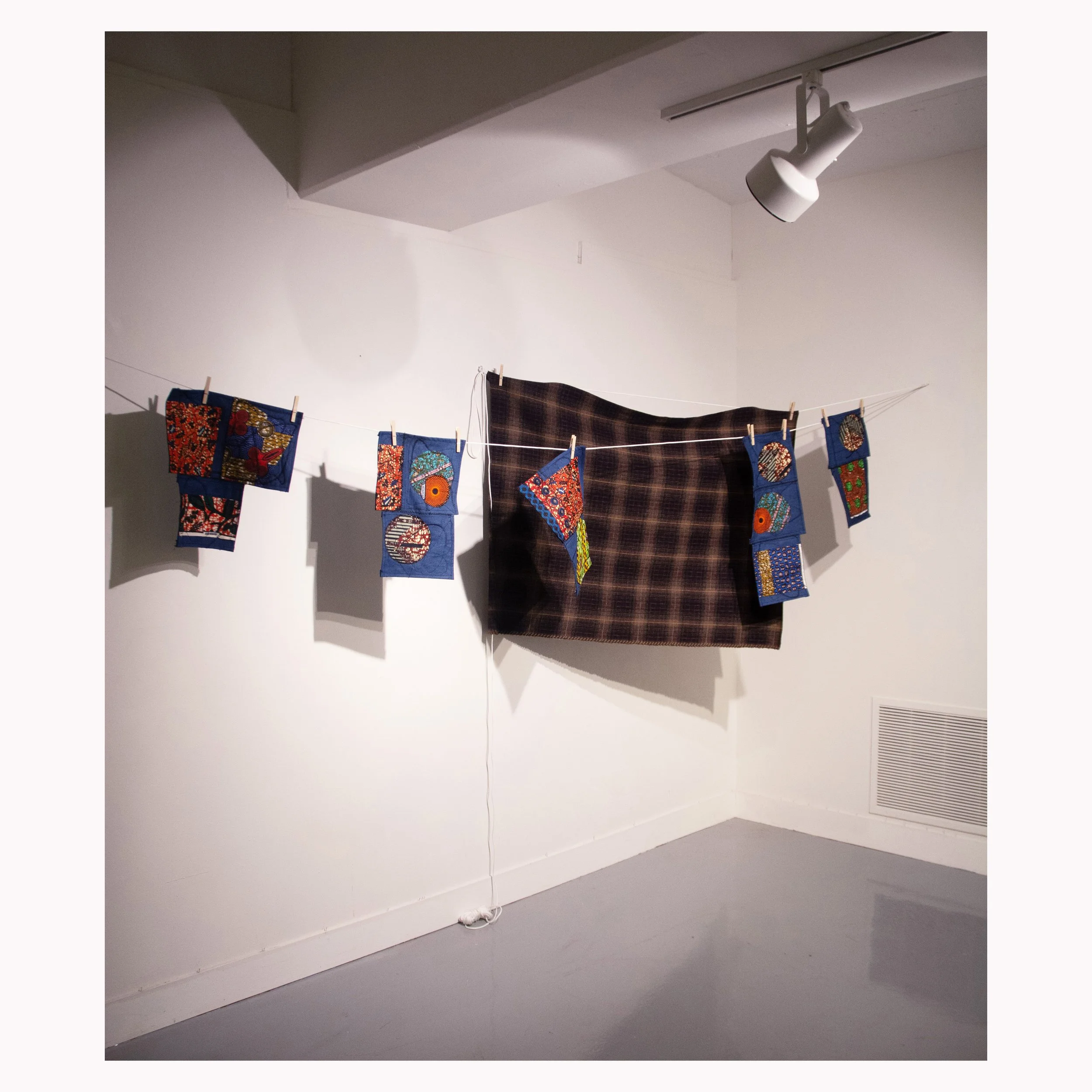 Material Study III, 2026. African wax print, denim and tartan on dry line – Dimensions variable.