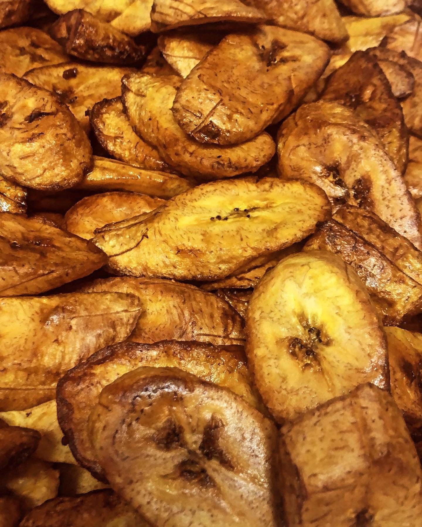 Close-up of sliced and fried plantains with a golden-brown exterior.