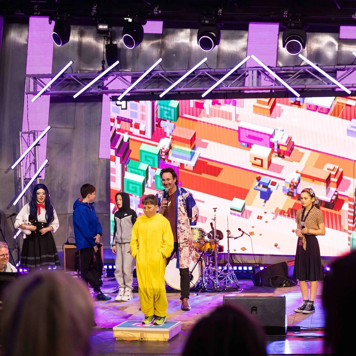 Kids playing Crossy Road on stage at Fed Square with custom controller by Louie Roots