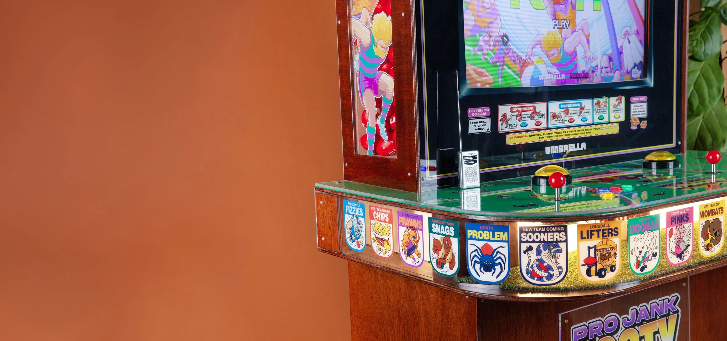 Close up of radio sitting on custom arcade cabinet for contemporary indie footy game.