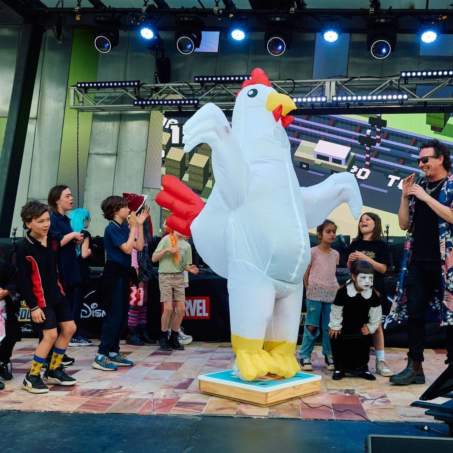 Kids playing Crossy Road on stage at Fed Square with custom controller by Louie Roots