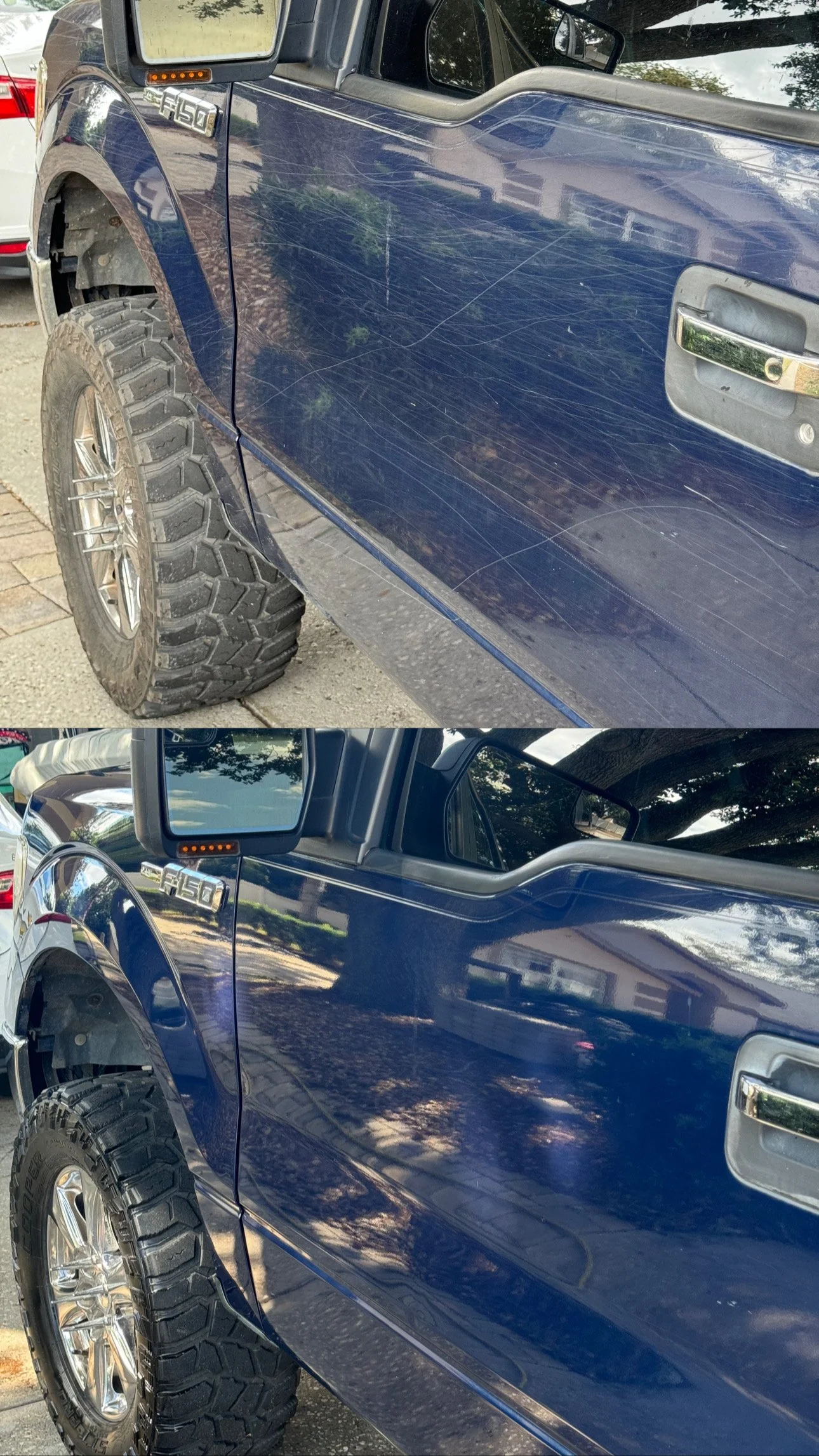 A blue pickup truck with a scratched door, chrome handle, large off-road tire, and side mirror, parked on a residential street with trees and houses reflected on the shiny surface.