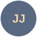 Dark blue circular badge with light beige initials 'JJ'