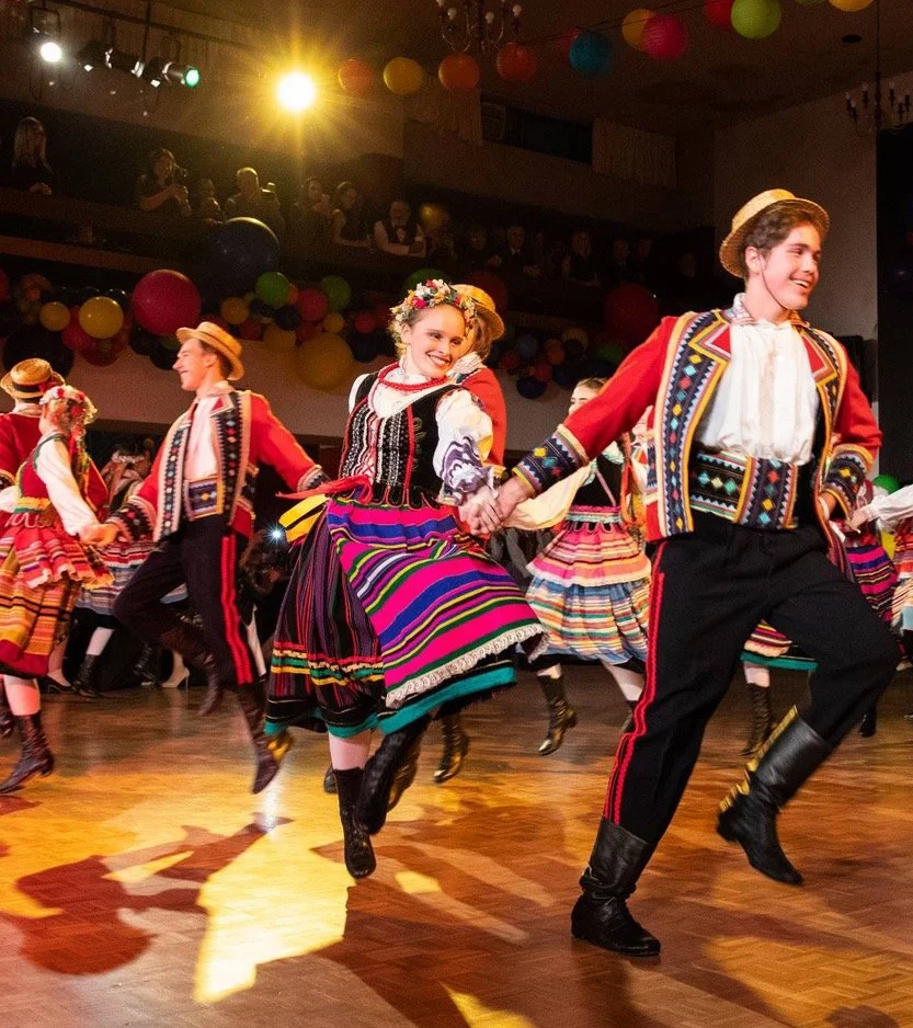 Young folk dancers in traditional Polish costume dancing in the Balcony Hall.