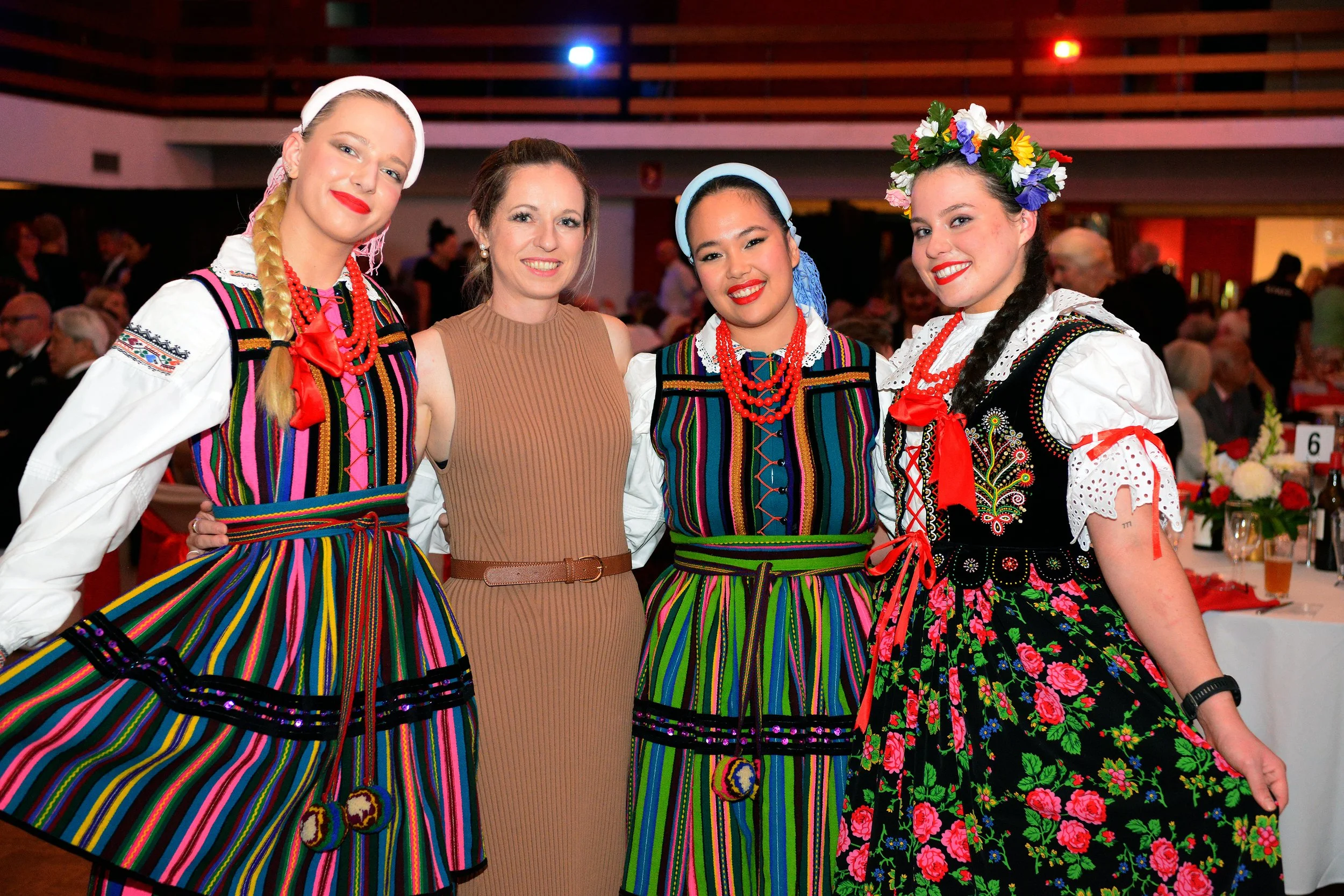 Four women in traditional Polish folk costume at a Dom Polski event.