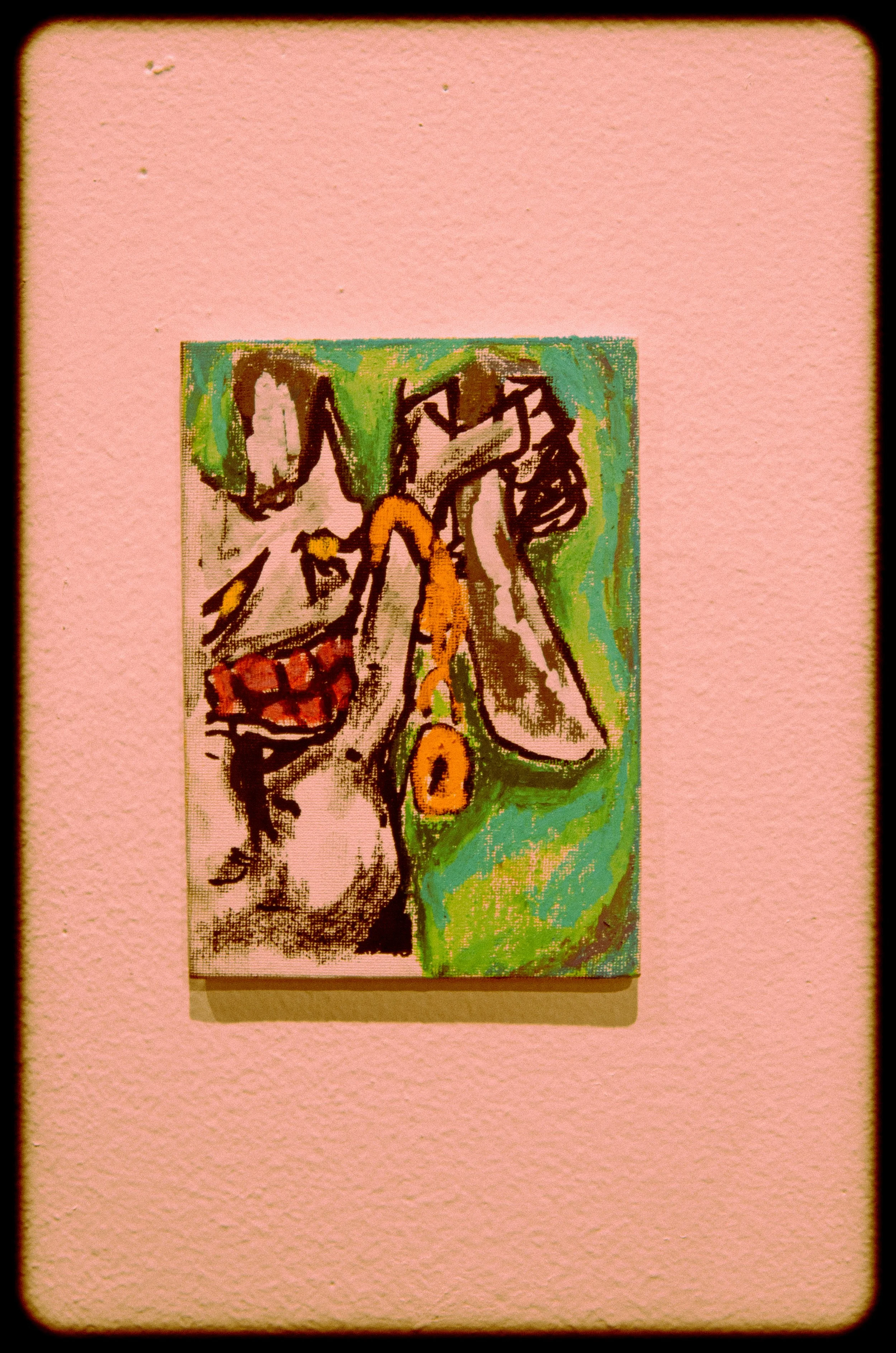 An abstract colorful painting on a pink wall.