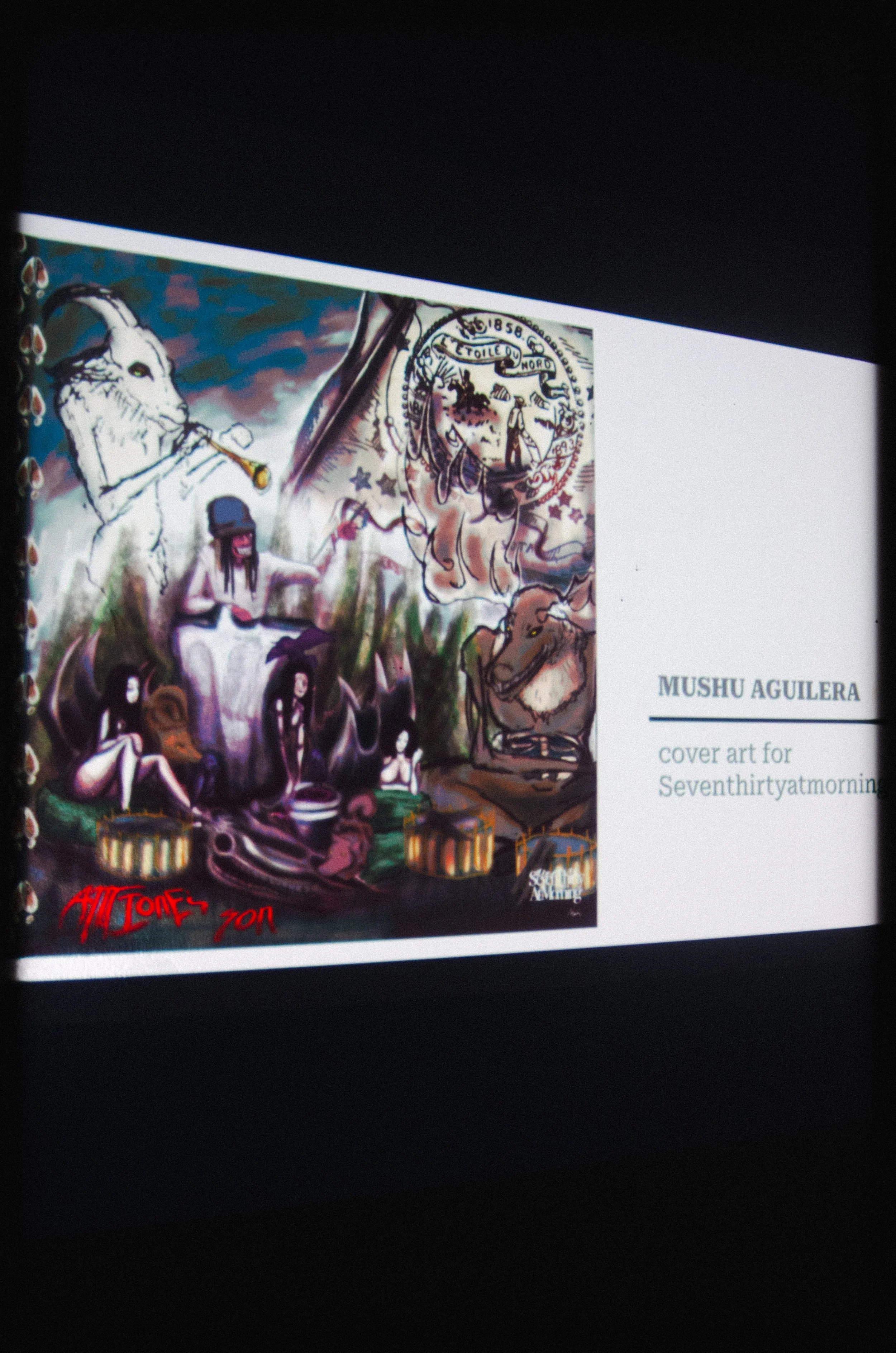Colorful cover art for Mushu Aguilera's album or publication, featuring artistic illustrations of animals, people, and abstract designs, signed with the name 'Adil Tobe' and the year 2010.