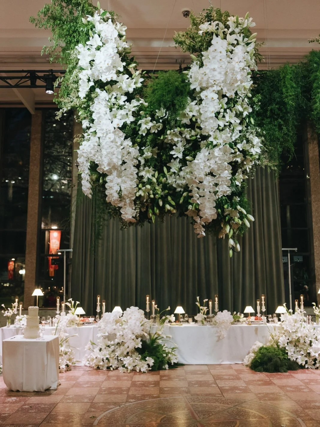 The MCA already has so much presence - with its tall windows, stone columns and marble finishes, we wanted to create florals that would match the grandeur. We stuck to a simple theme of white &amp; green, weaving lilies &amp; orchids through textures