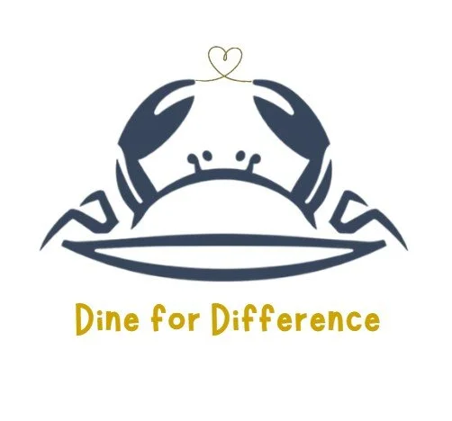Illustration of a crab with two hands holding a heart-shaped object above its shell, along with the text 'Dine for Difference' in yellow.