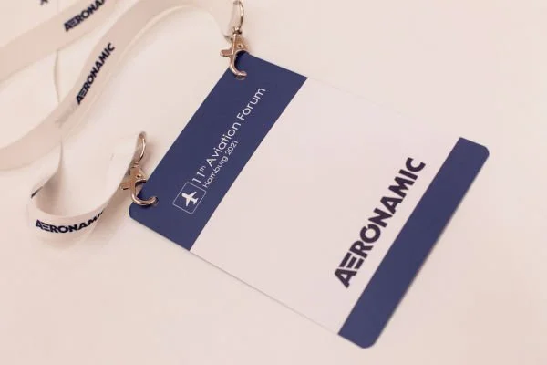 A lanyard and badge for the 11th Aviation Forum with Aeronautic branding.