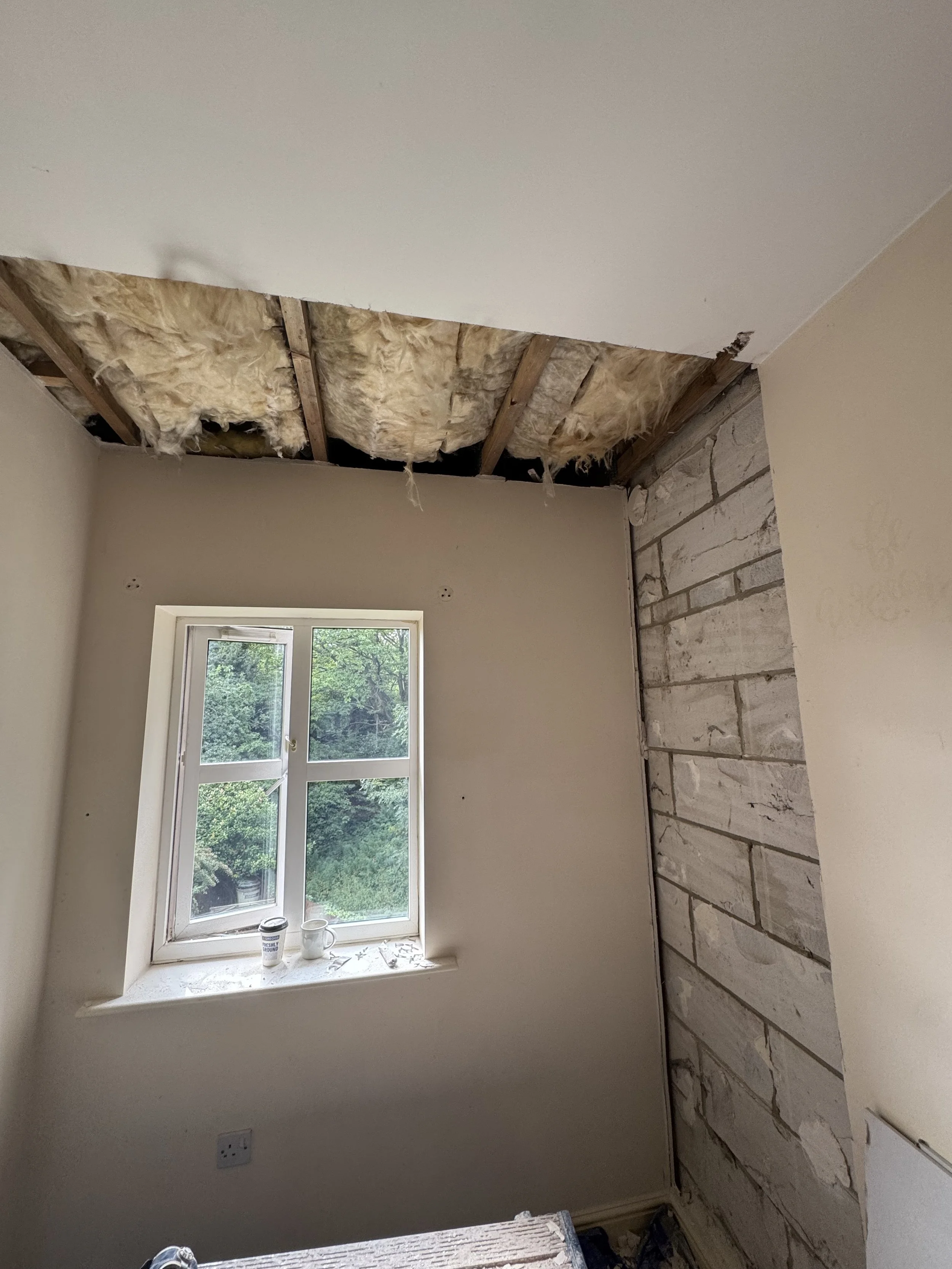 Water damaged plaster removed after pipe leak caused water damage