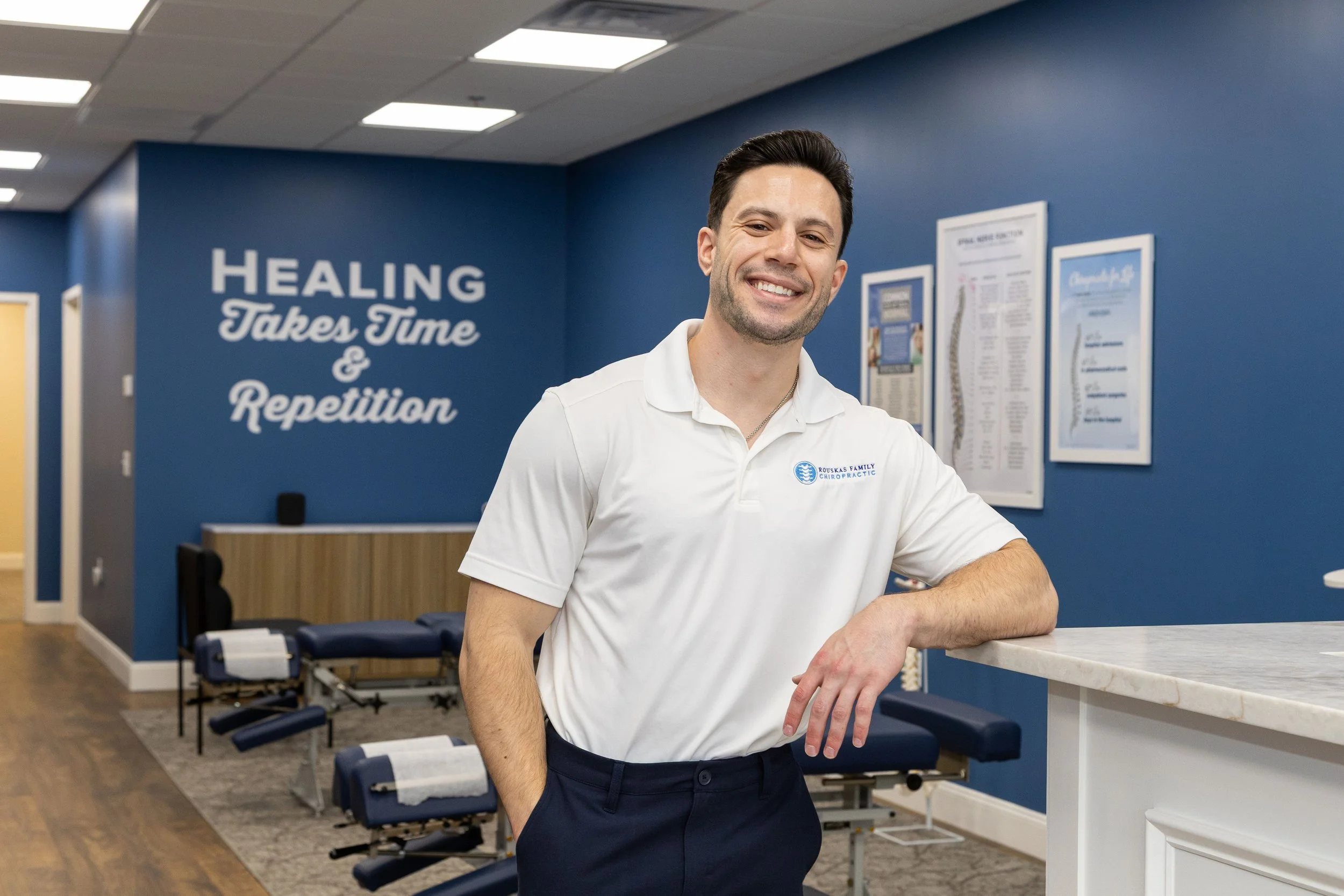 Dr. Mike Rouskas, a Fairfield chiropractor, stands inside his clinic, providing personalized care for patients of all ages.