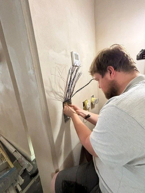 Our Engineer (Tom) installing working on an electrical outlet..
