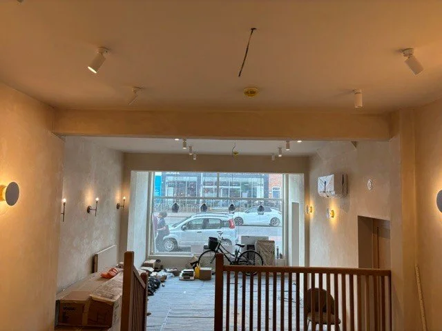 Restaurant Margarets , Cambridge The room has wooden flooring, wall-mounted lights, , and a staircase or railing separates the room from a lower area.