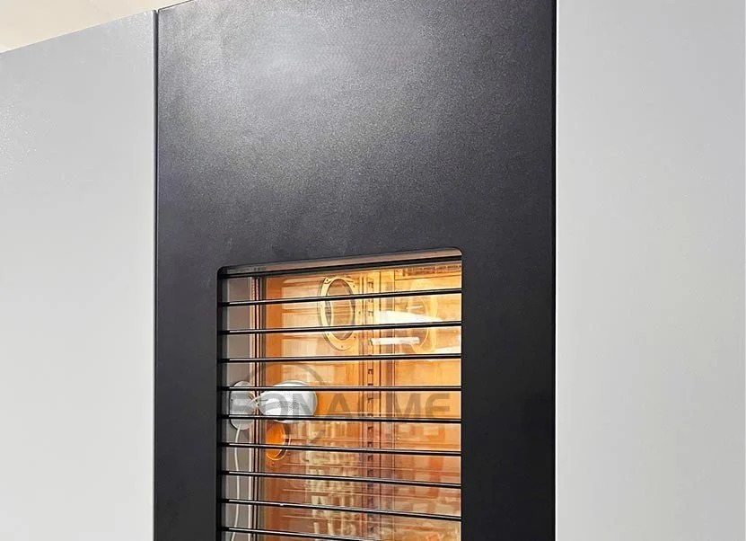 Close-up of a modern refrigerator door with a small window showing the inside, which has warm lighting and various kitchen items.