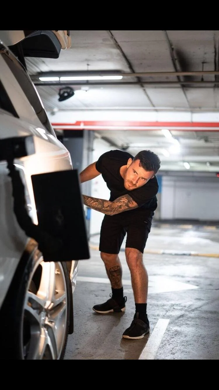 Paintless dent repair technician removing dents from vehicle panel in Sydney