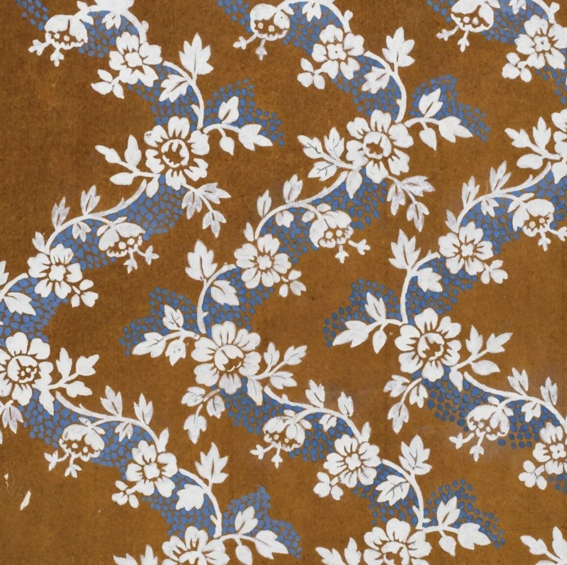 A floral pattern by J. D. Cornaud with white flowers and leaves on a brown background, accented with blue details.