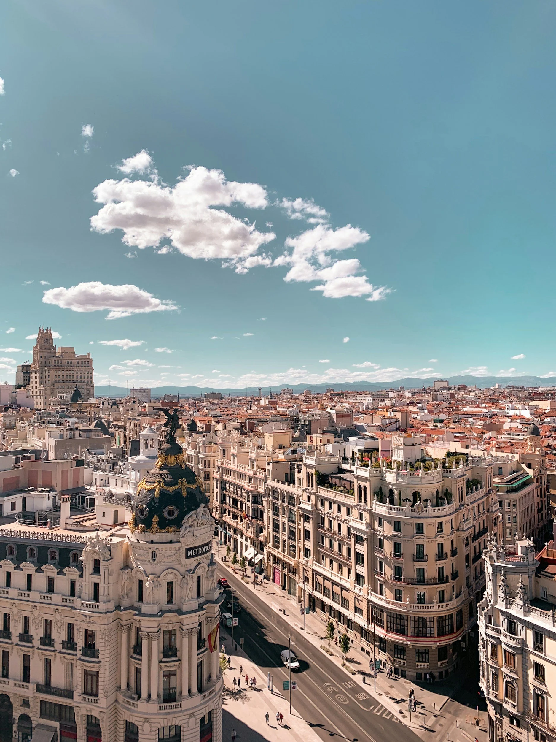 Madrid skyline viewed from the rooftop of the Círculo de Bellas Artes, with historic buildings under a blue sky