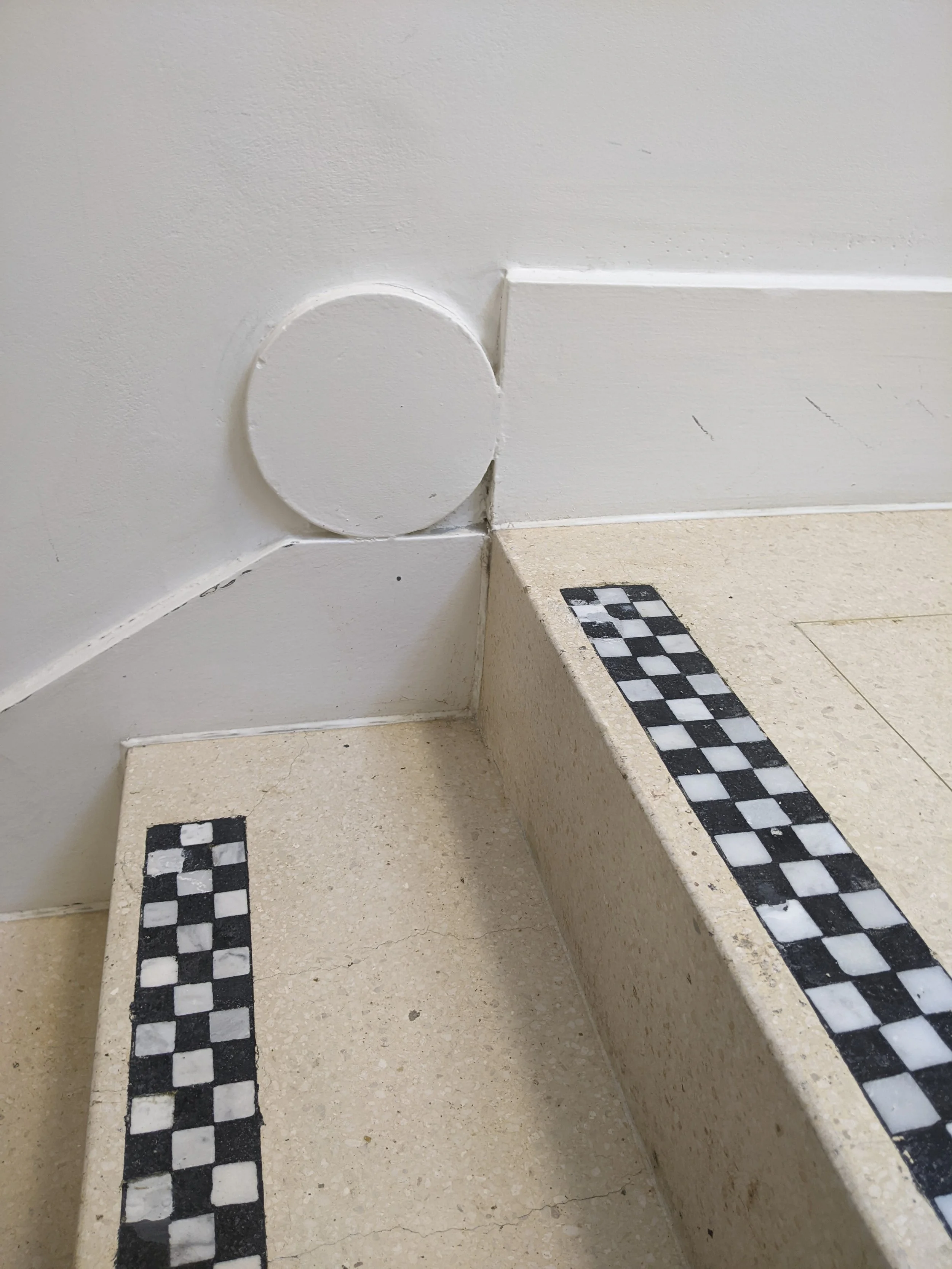 Close-up of a geometric skirting detail and tiled treads by Lutyens.