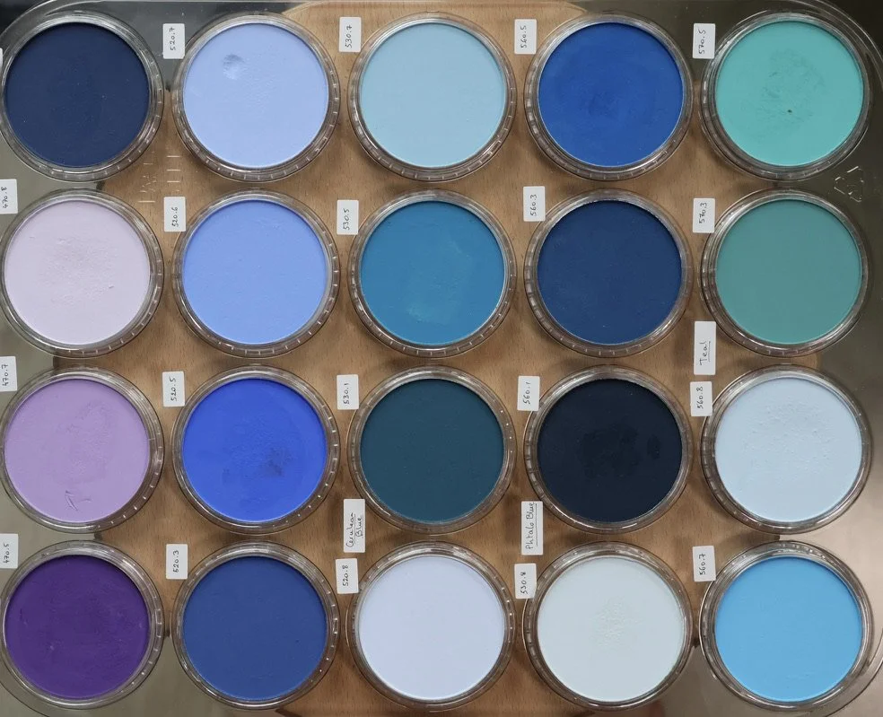 Collection of 20 Panpastels filled with various shades of blue, purple, and teal pastel pigments.