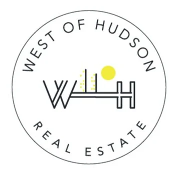 Logo for West of Hudson Real Estate featuring a circular design with the company name and a stylized depiction of buildings and sun.