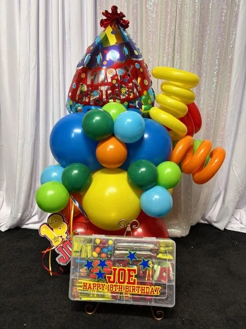 Colorful birthday balloon arrangement with a 'Happy 18th Birthday' sign