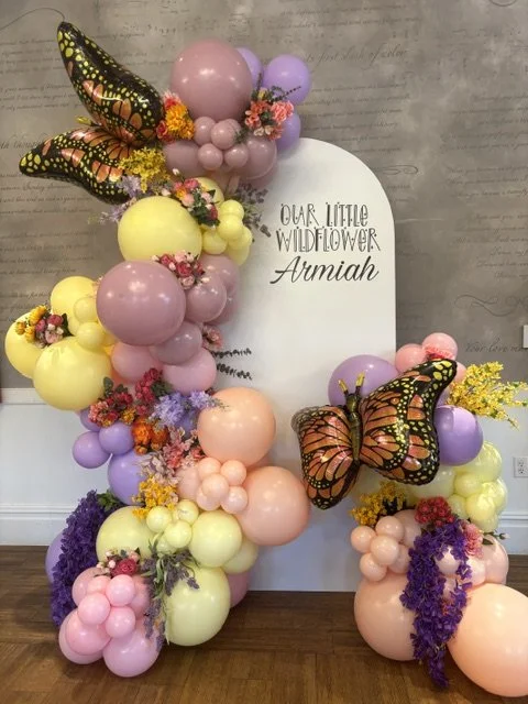 A 7 foot chiara backdrop with a balloon garland and faux florals for a baby shower in New Hope PA