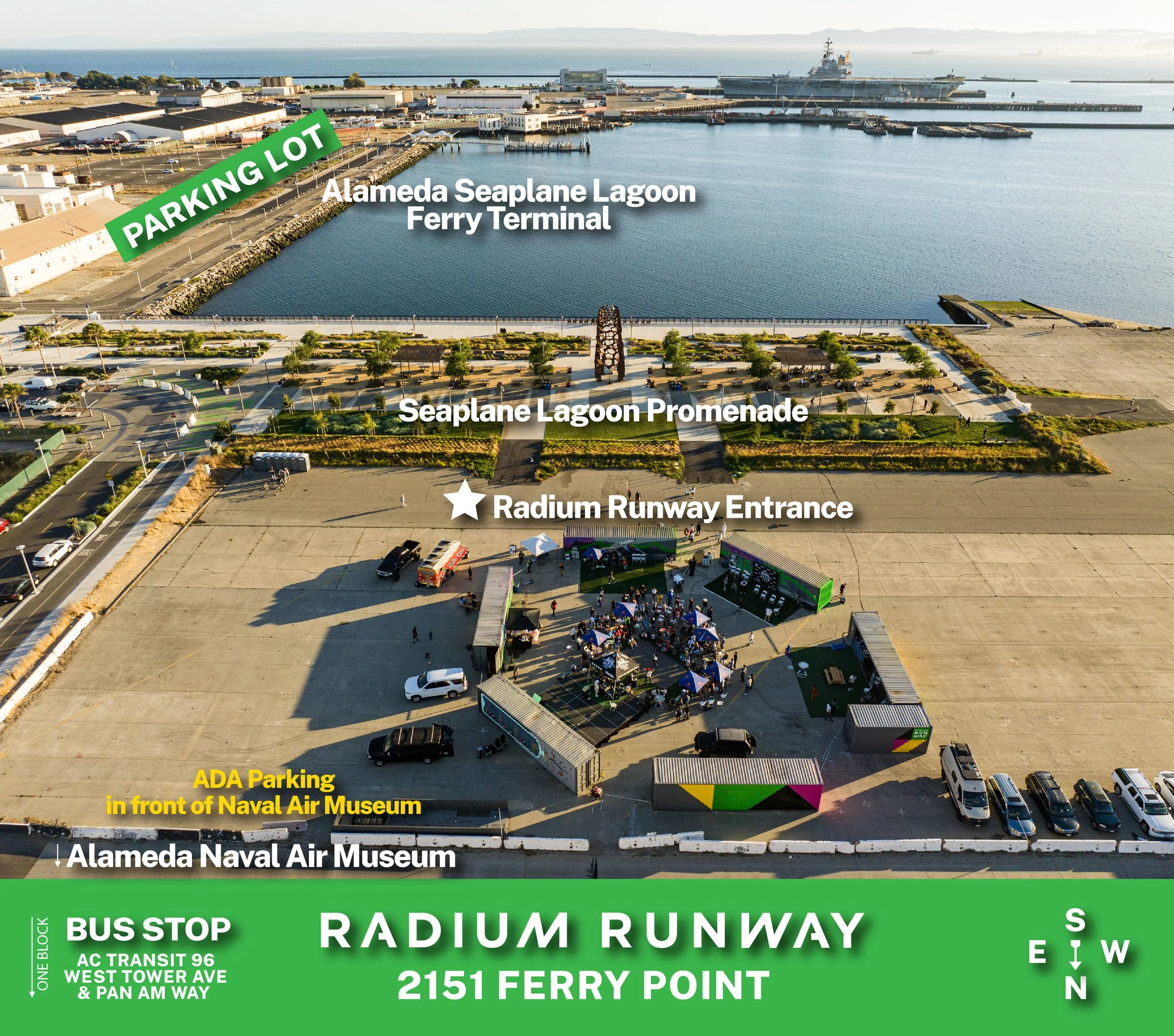 Aerial view of Radium Runway at 2151 Ferry Point, showing the ADA Parking area in front of Naval Air Museum, Radium Runway Entrance, Seaplane Lagoon Promenade, Alameda Seaplane Lagoon Ferry Terminal, Alameda Seaplane Lagoon Parking Lot, and the nearby naval ships and harbor.