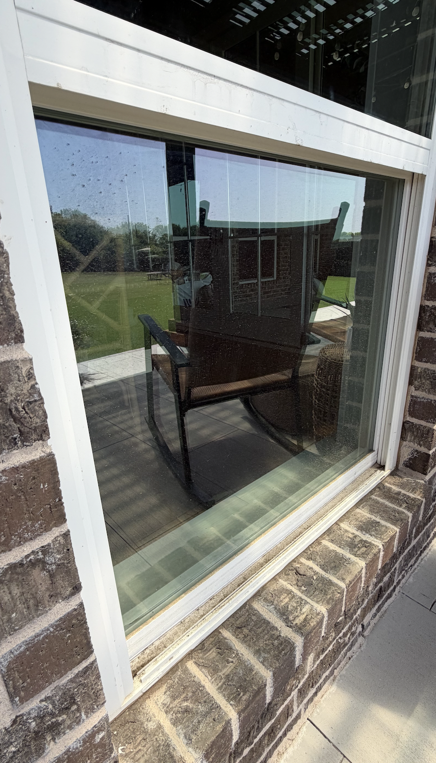 Very dirty exterior window that has dust, dirt, pollen, and weather residue buildup.