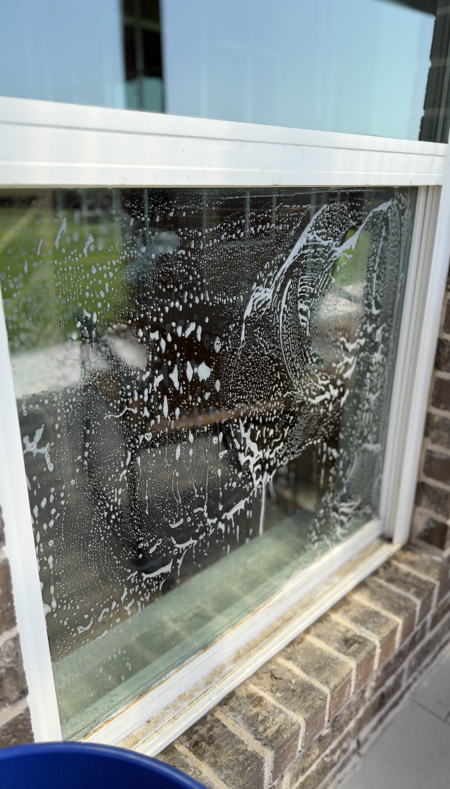 During window cleaning to remove grime and weather buildup using soap and ecofriendly materials.