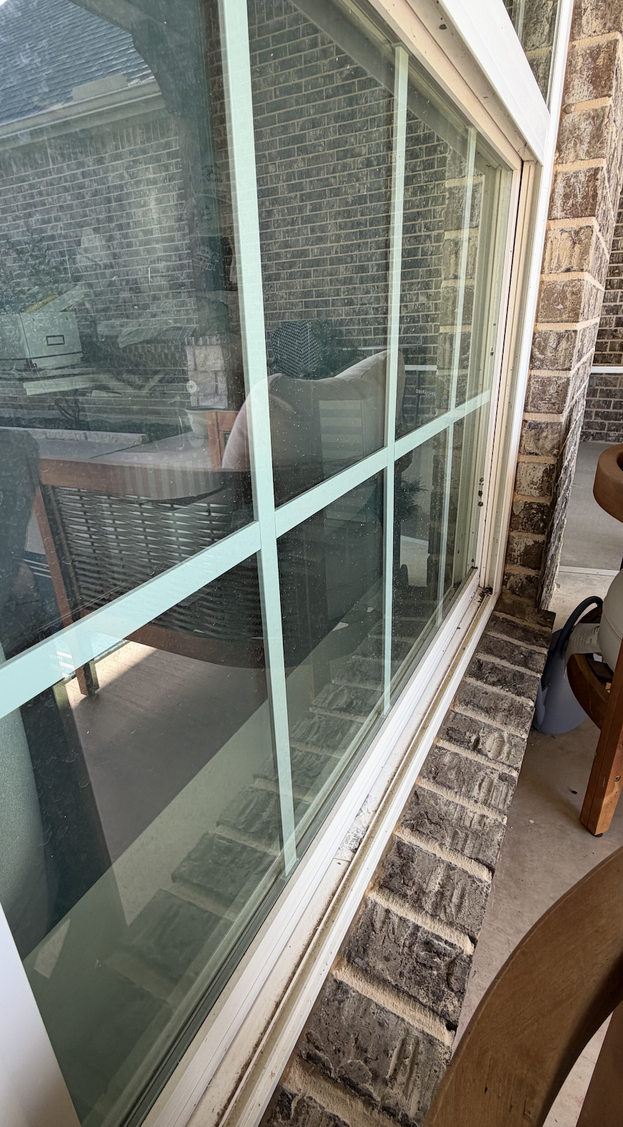 Before cleaning office window with lots of dirt and mineral deposits on window glass pane.