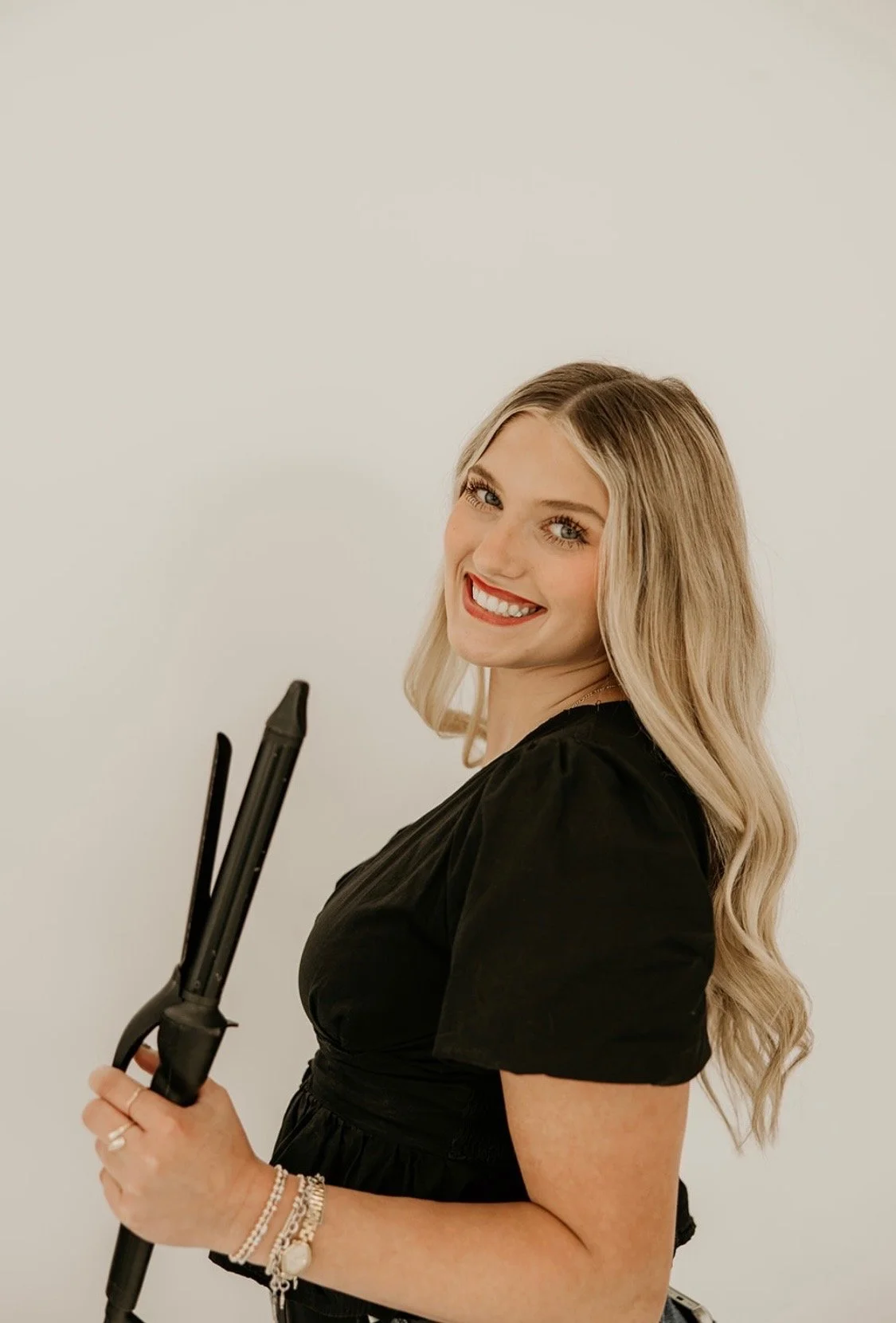 stylist using The Last Bead Method™- an innovative hair extension installation technique designed to help stylists create cleaner, more precise, secure, and seamless luxury extension installations.