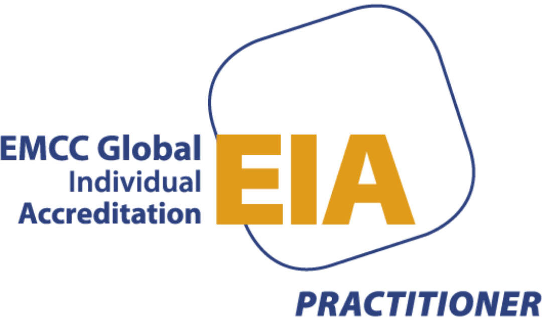 Logo for EMCC Global, with the words 'Individual Accreditation' and 'Practitioner', featuring large gold letters 'EIA' and a blue outlined shape.