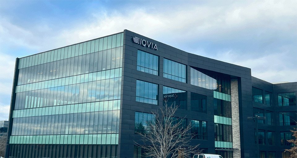 Modern multi-story office building with glass windows and the sign 'LOVIA' on the top left corner.