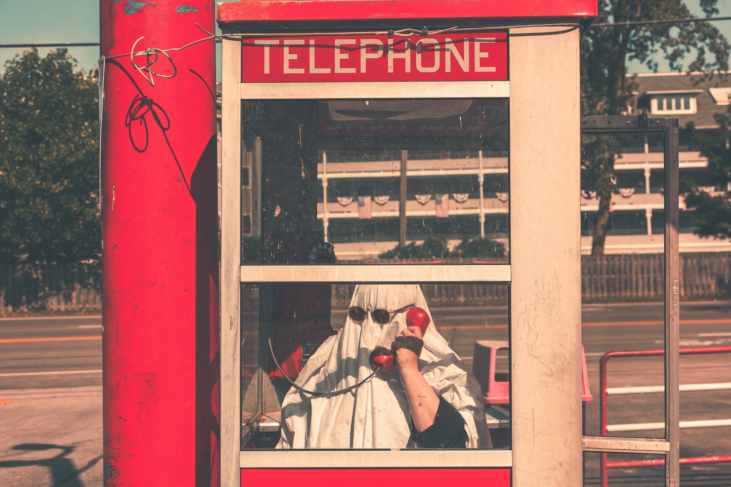 Ghost character in a phonebooth. Road, phonebooth, telephone, ghost.