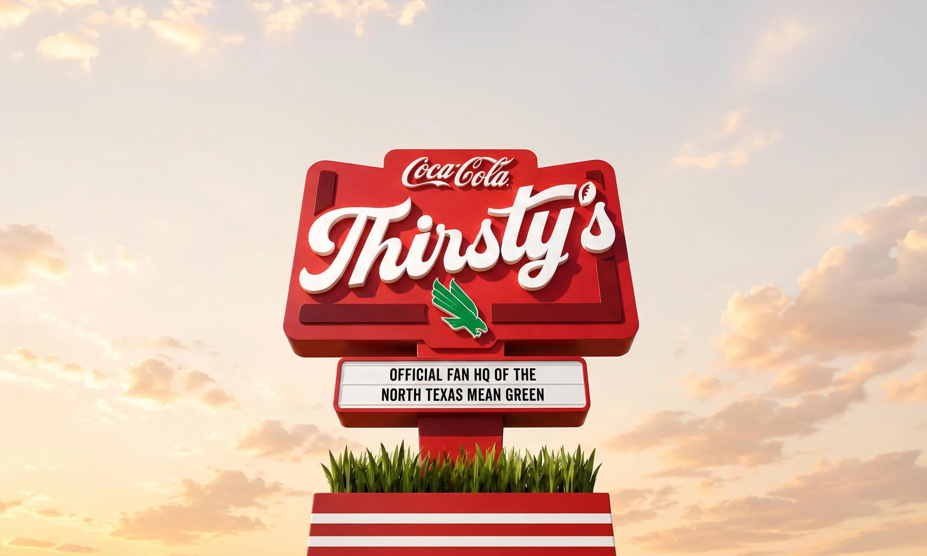 Coca-Cola Thirsty's sign with a green eagle logo and a white sign below reading 'Official fan HQ of the North Texas Mean Green', set against a sky with clouds at sunset.