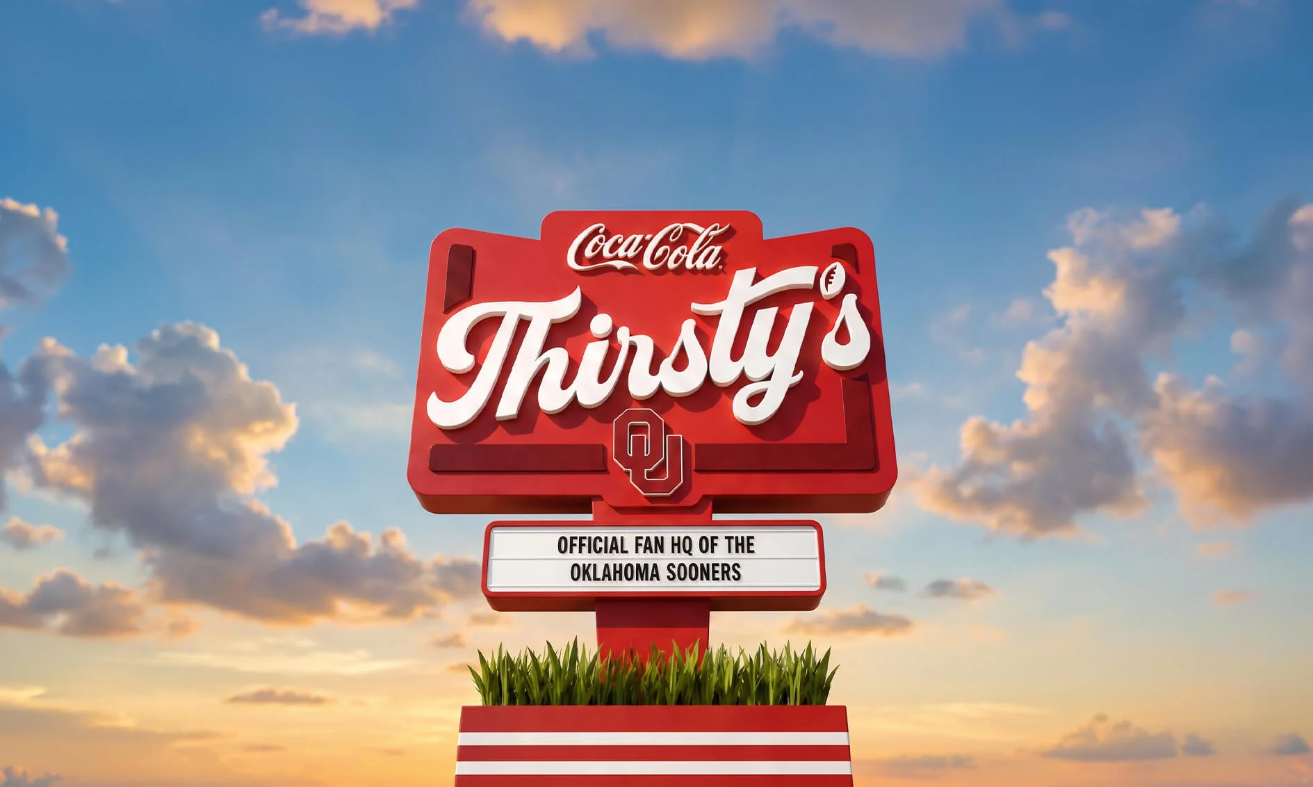 Sign for Oklahoma Sooners football team with the text 'Coca Cola Thirsty's' and 'Official Fan HQ of the Oklahoma Sooners' against a sunset sky with clouds.