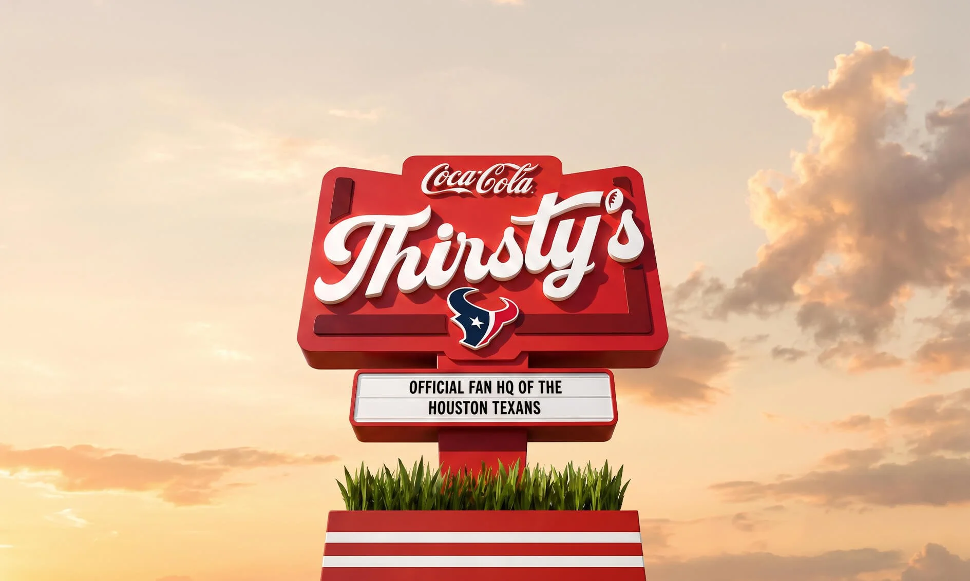 A large red sign with the Coca-Cola logo and the word 'Thirsty's' in white cursive letters. Below, it says 'Official Fan HQ of the Houston Texans' and features the Texans' logo of a bull's head with a star. The sign is situated above green grass, against a sunset sky with clouds.