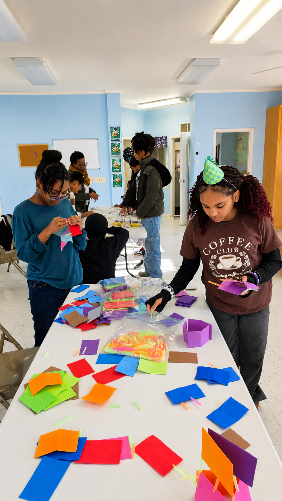 Children engaging in arts and crafts with colorful paper and straws in a classroom.