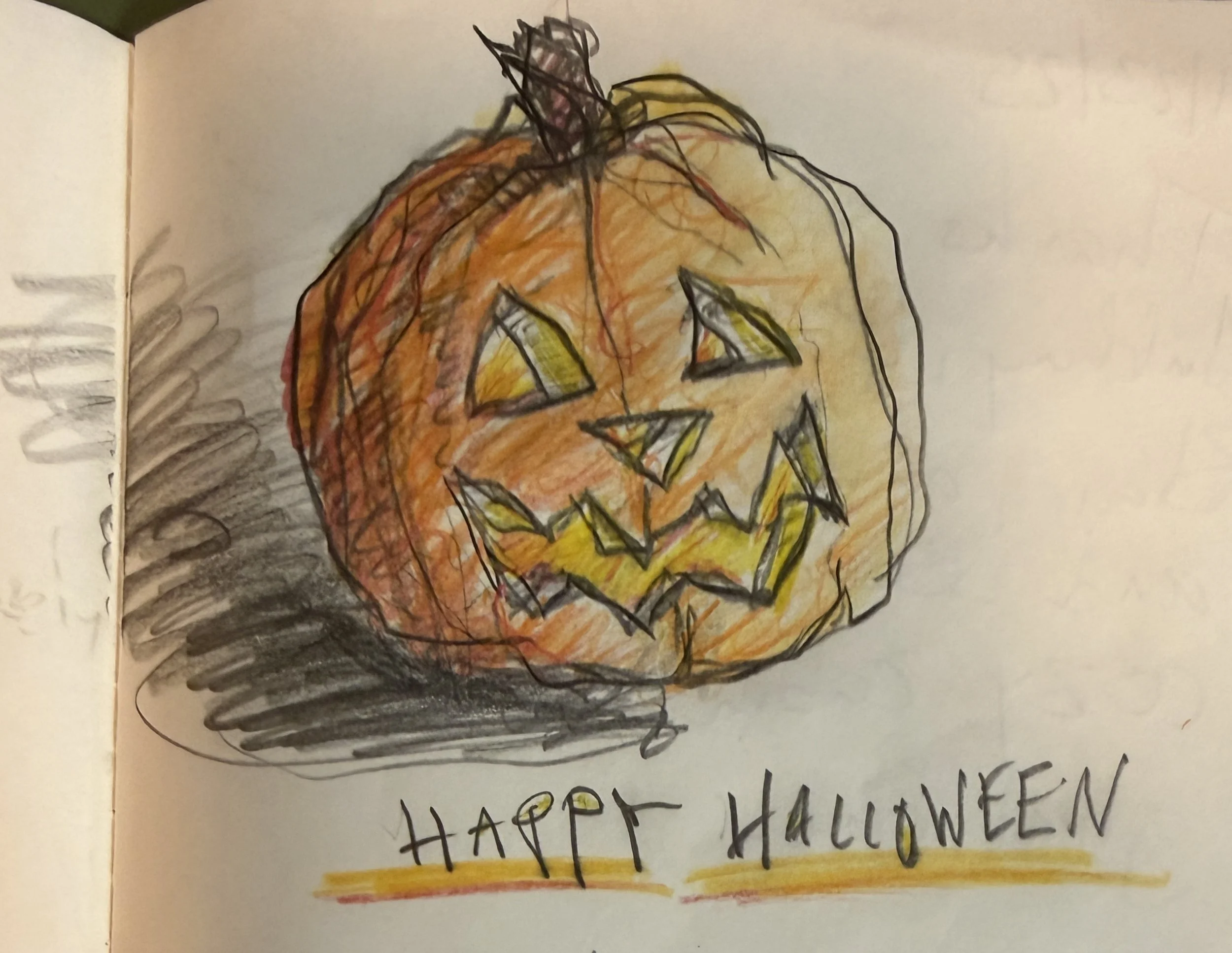 A drawing of a pumpkin with a carved face, colored in orange with green eyes, a yellow nose, and a mouth with sharp teeth. There is handwritten text below the pumpkin that says 'Happy Halloween' in black ink.