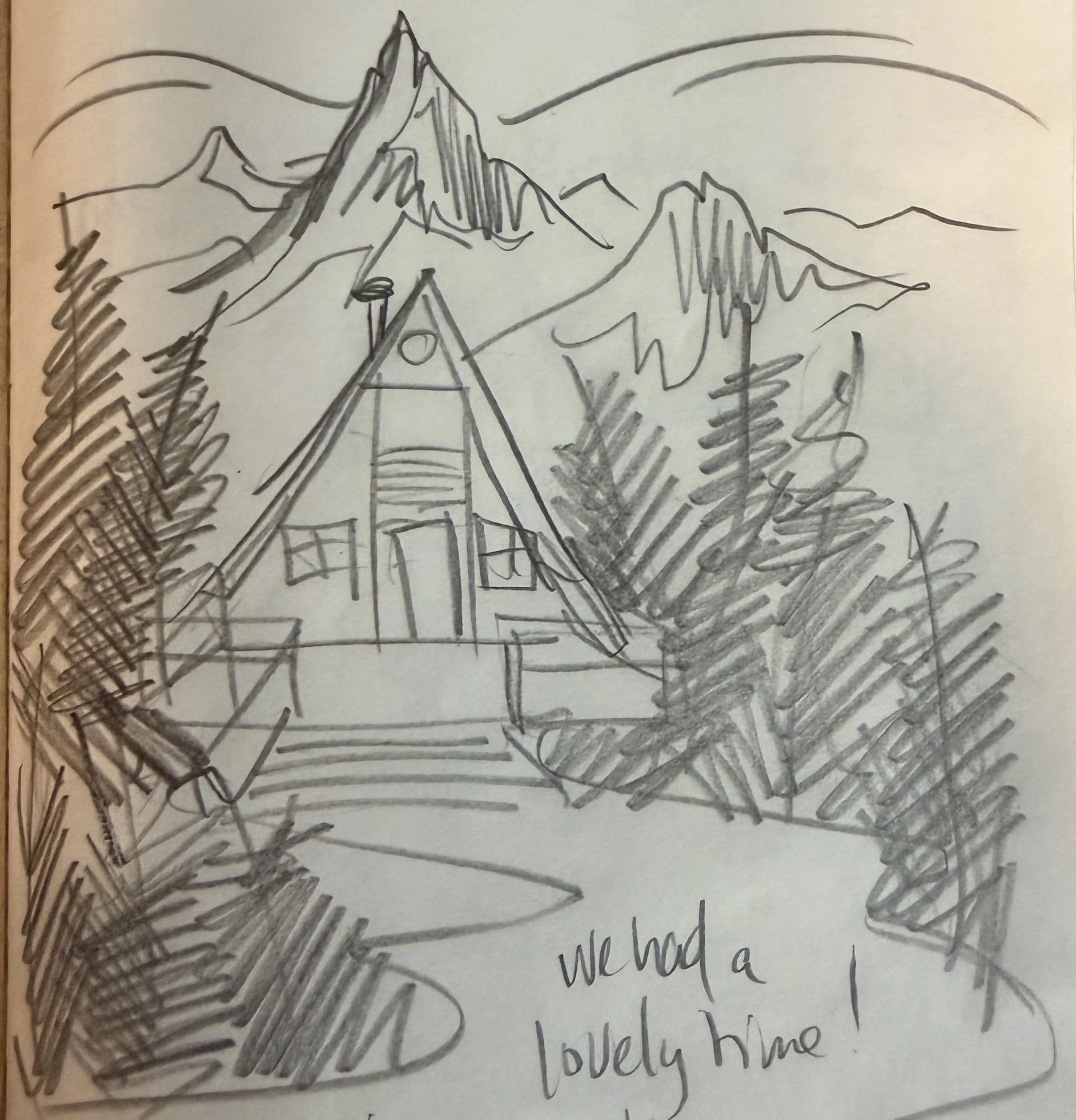 A black and white sketch of a mountain landscape with a house, trees, and hills in the background. There is handwritten text below the drawing that reads, "we had a lovely time."