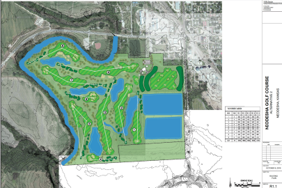 A detailed map of a golf course, showing fairways, greens, water hazards, and surrounding terrain, with areas marked in different shades of green and blue for water features.