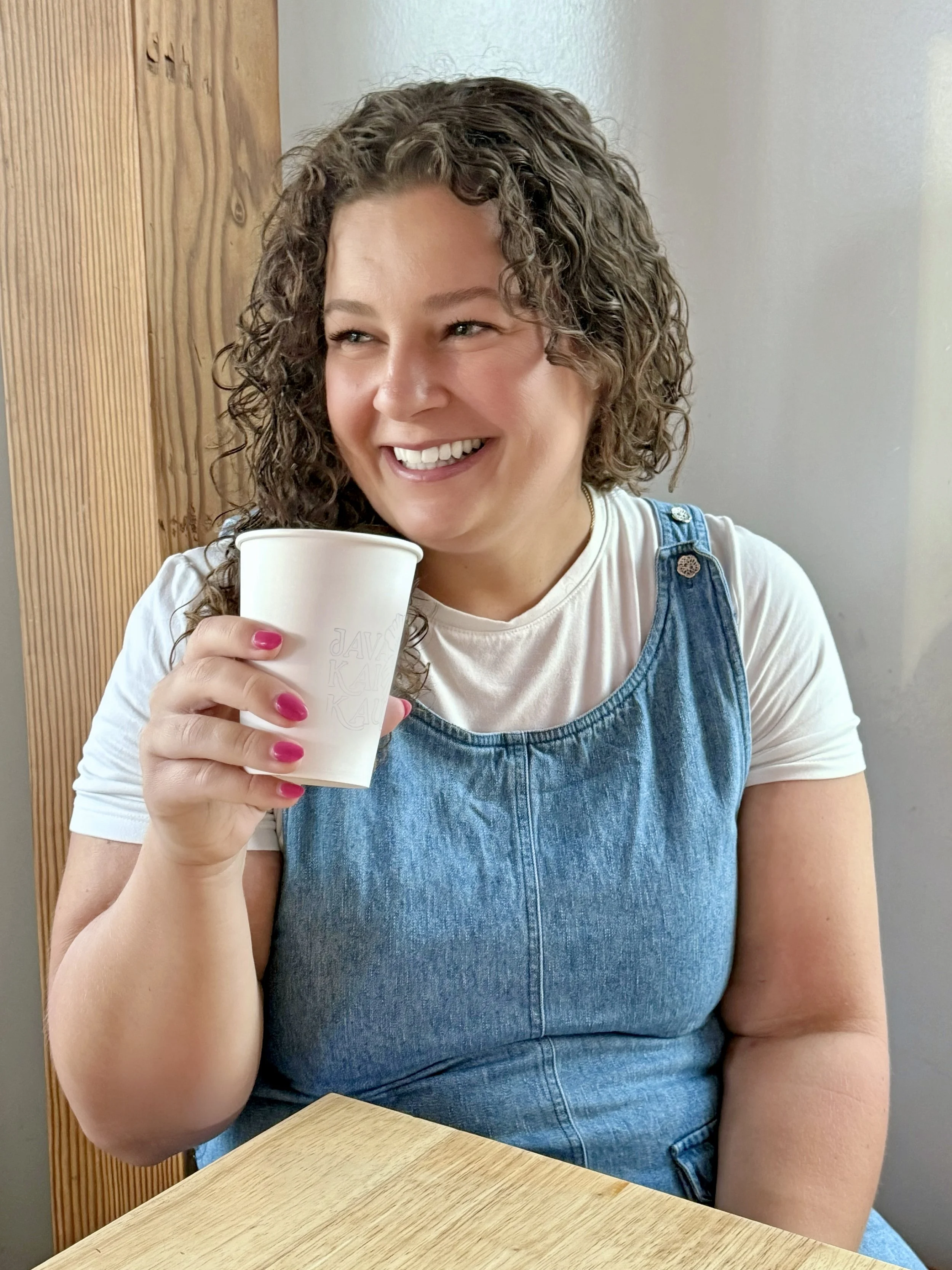 Lacey Budd, co-founder of DigitalmarketHERs, enjoying coffee while planning her next career move, representing career reinvention, remote work, and women building online businesses.